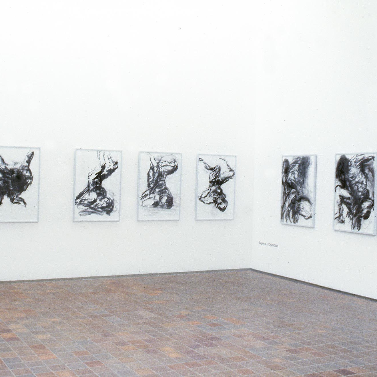 Salle d'exposition avec des dessins aux murs.