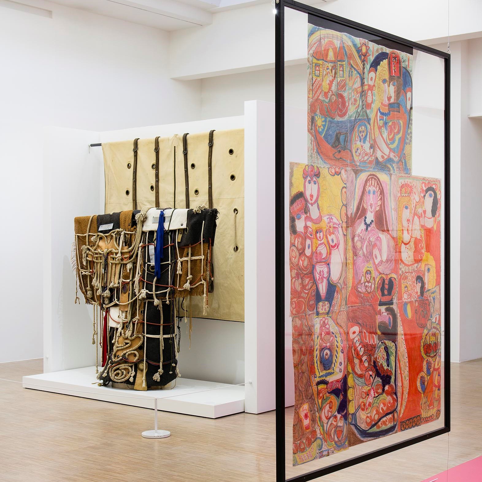 Salle d'exposition avec dessin et installation de tissus.