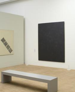 Photographie salle d'exposition avec banc.